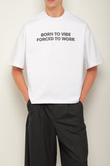 White oversized t-shirt "Born to vibe, Forced to work"